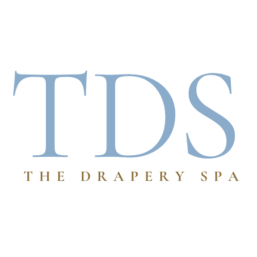 The Drapery Spa logo in blue serif font (decorative, use alt="")